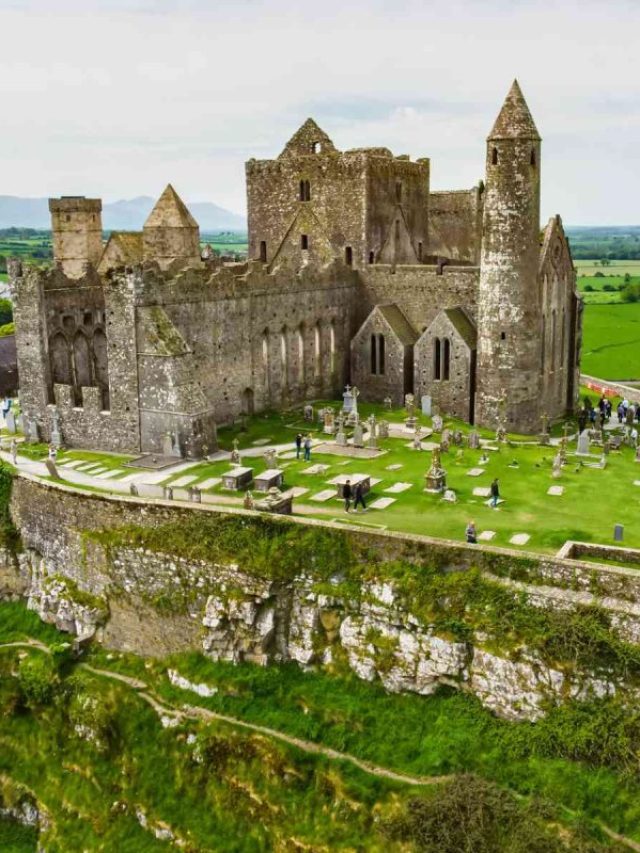 Overhead view of the Rock of Cashel in Ireland with adults and kids roaming around.